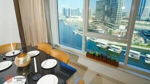 Un comedor con vista a un puerto deportivo y edificios altos.