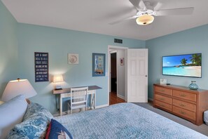 A bedroom with a bed, a desk, a dresser, and a ceiling fan. - Less than 1/2 mile to beach.  Community pool. (St. Simons Island)