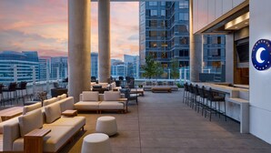 A rooftop lounge with outdoor seating, a bar, and a city view. - JW Marriott Dallas Arts District Hotel (Dallas)