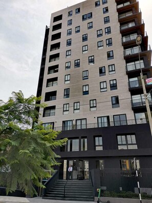 Stylish residential building with secure entry and landscaped surroundings.