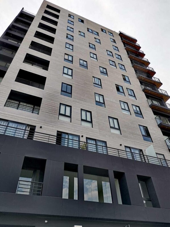 Enjoy the contemporary architecture and expansive balconies with metal railings.