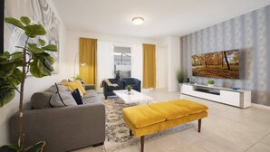 Ein modernes Wohnzimmer mit einer Couch, Hocker, Couchtisch und einem Fernseher auf einem weißen Schrank.