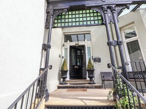 A building entrance with a black door, a small potted plant, and a number '13' sign. - Ismay Dining Room Suite - Titanic Interest Beach View (Liverpool)