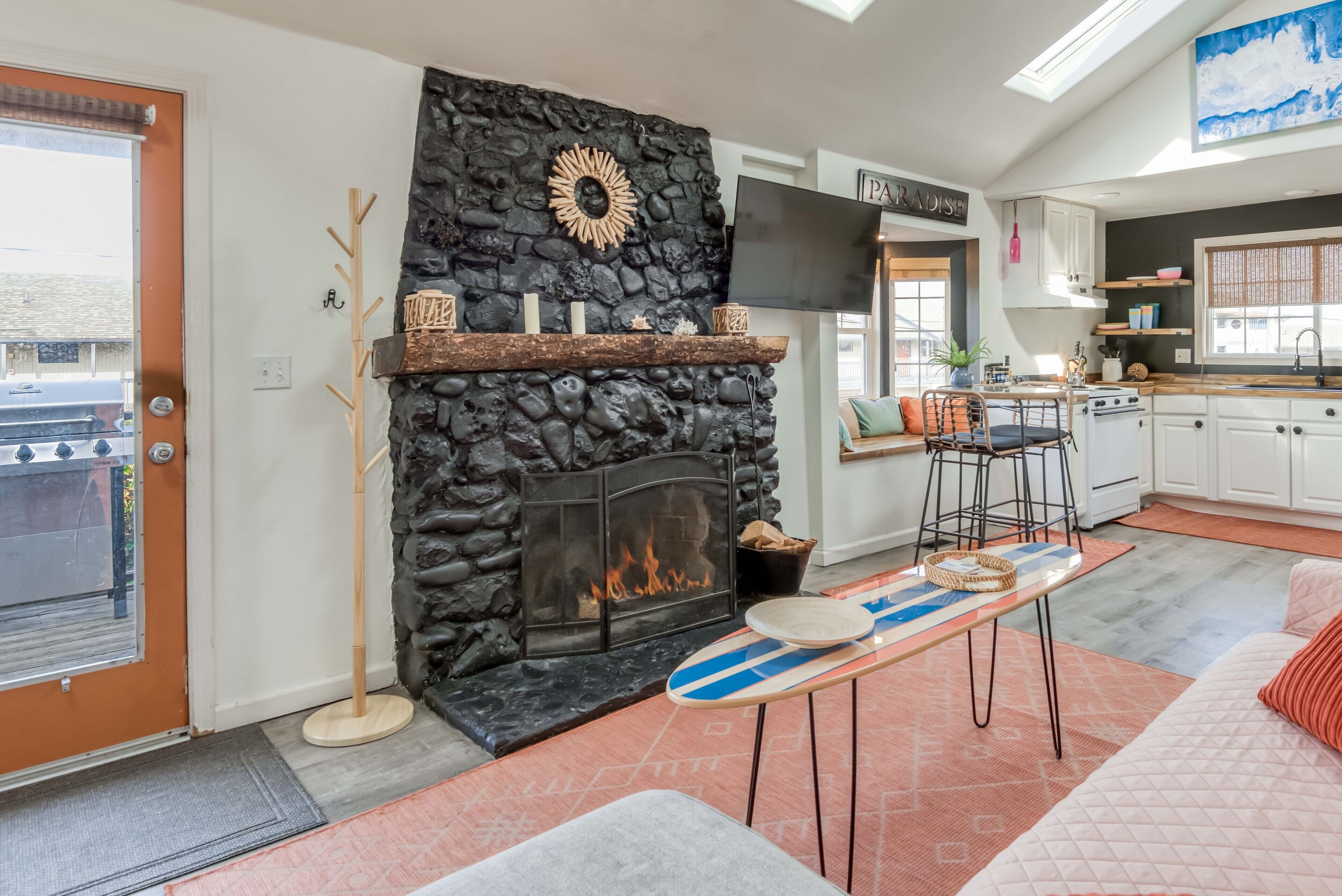 Adorable beachy cottage with a rock chimney is only ½ block from the beach!