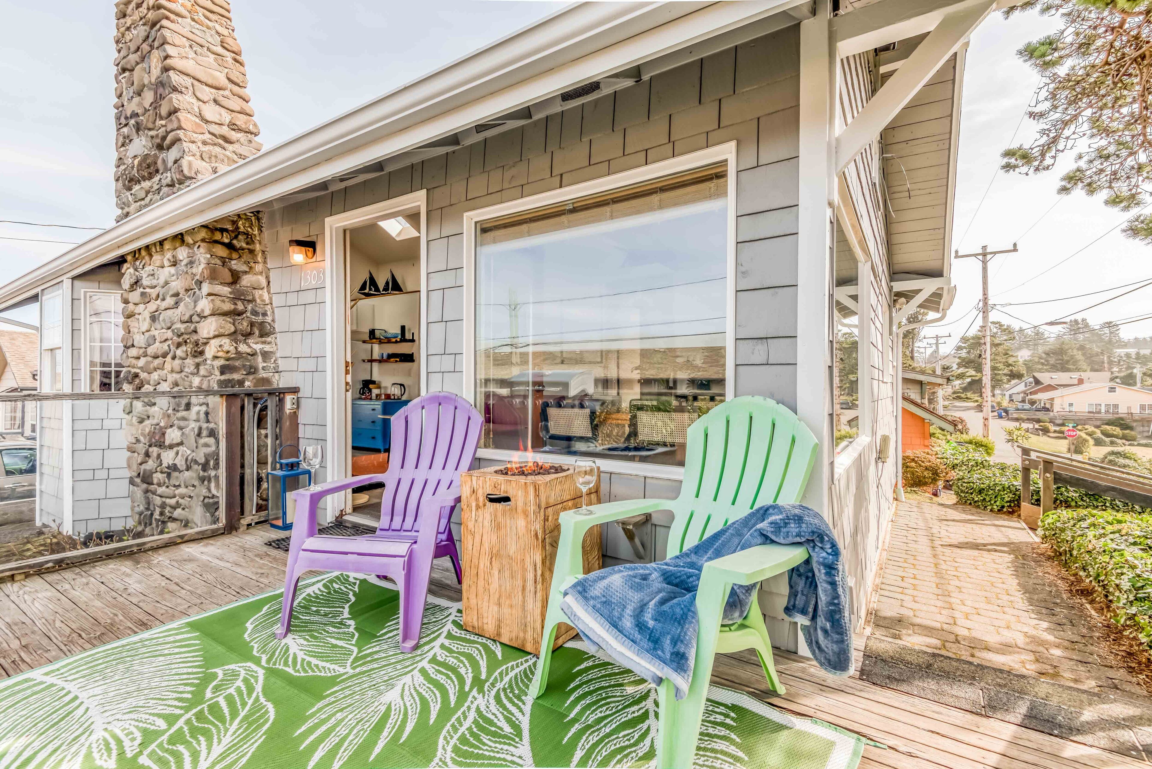 Adorable beachy cottage with a rock chimney is only ½ block from the beach!