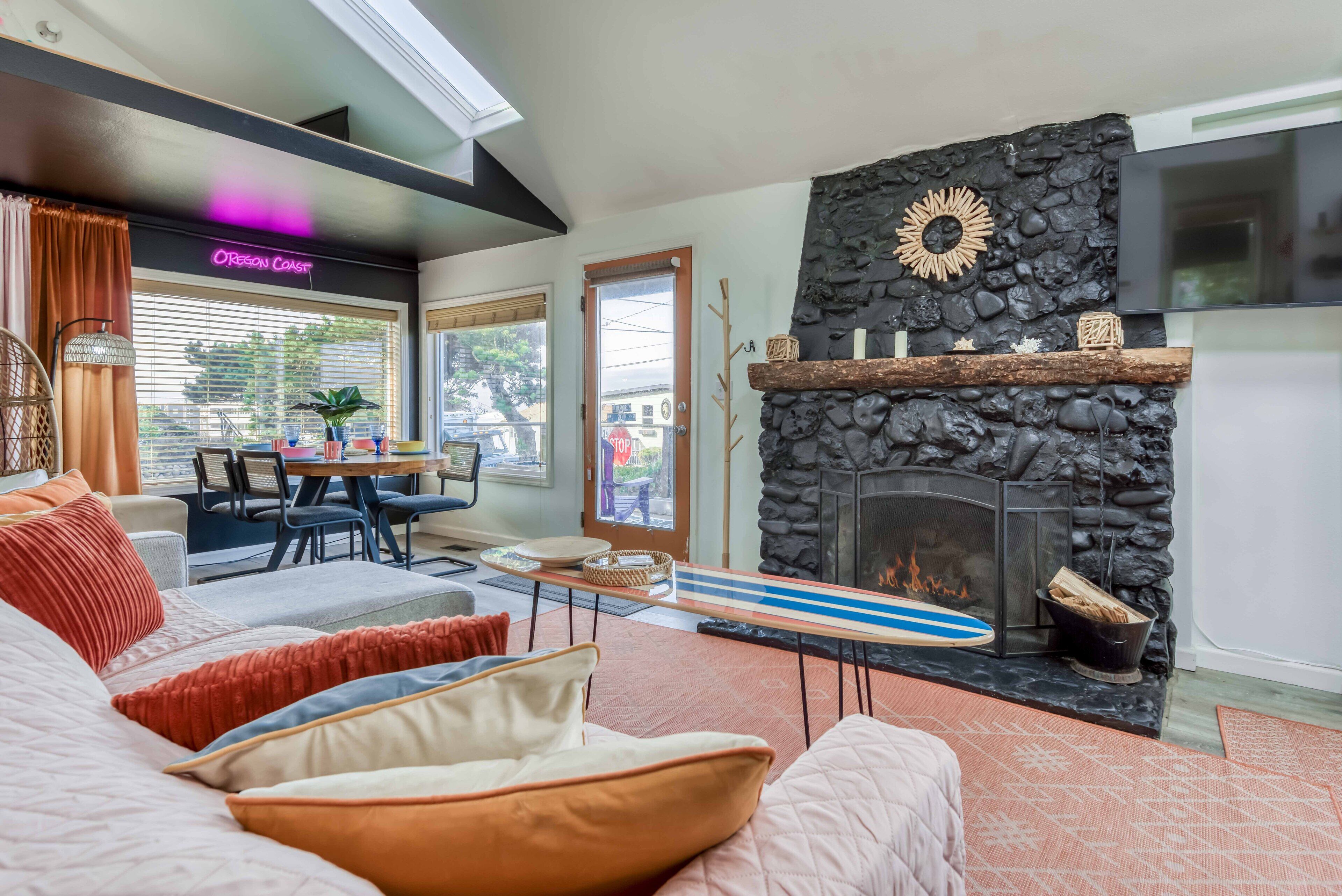 Adorable beachy cottage with a rock chimney is only ½ block from the beach!