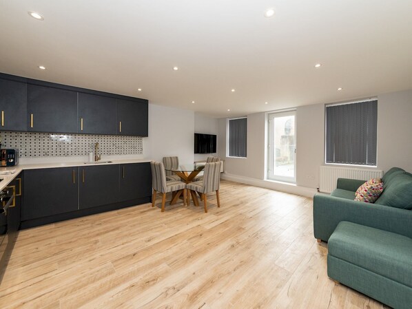 Enjoy meals at the dining table, relax on the sofa, and unwind in the spacious living area.