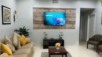 Family House, 3 Bedrooms, Ground Floor | Living area | 58-inch Smart TV with cable channels, TV