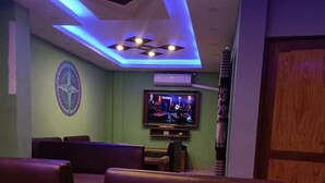 A restaurant with booths and a table with a tissue box and a glass of water. - Harrys Home  (Kathmandu)