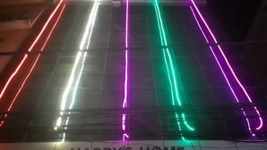 A tiled floor with neon lights in red, green, and purple colors. - Harrys Home  (Kathmandu)