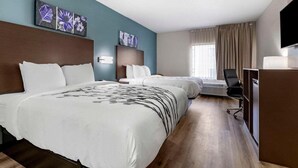 A hotel room with two beds, a desk, a chair, and artwork on the walls. - Sleep Inn & Suites Grovetown - Augusta West (Grovetown)