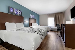 A hotel room with two beds, a desk, a chair, and artwork on the walls. - Sleep Inn & Suites Grovetown - Augusta West (Grovetown)