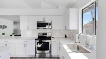 Fridge, dishwasher, coffee/tea maker, cookware/dishes/utensils