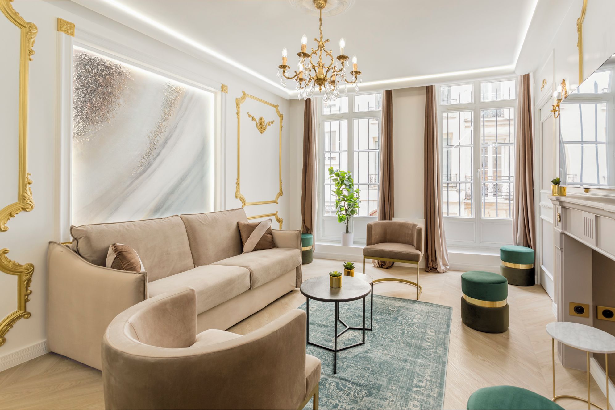 A modern living room with a beige sofa, a round coffee table, and a green ottoman.