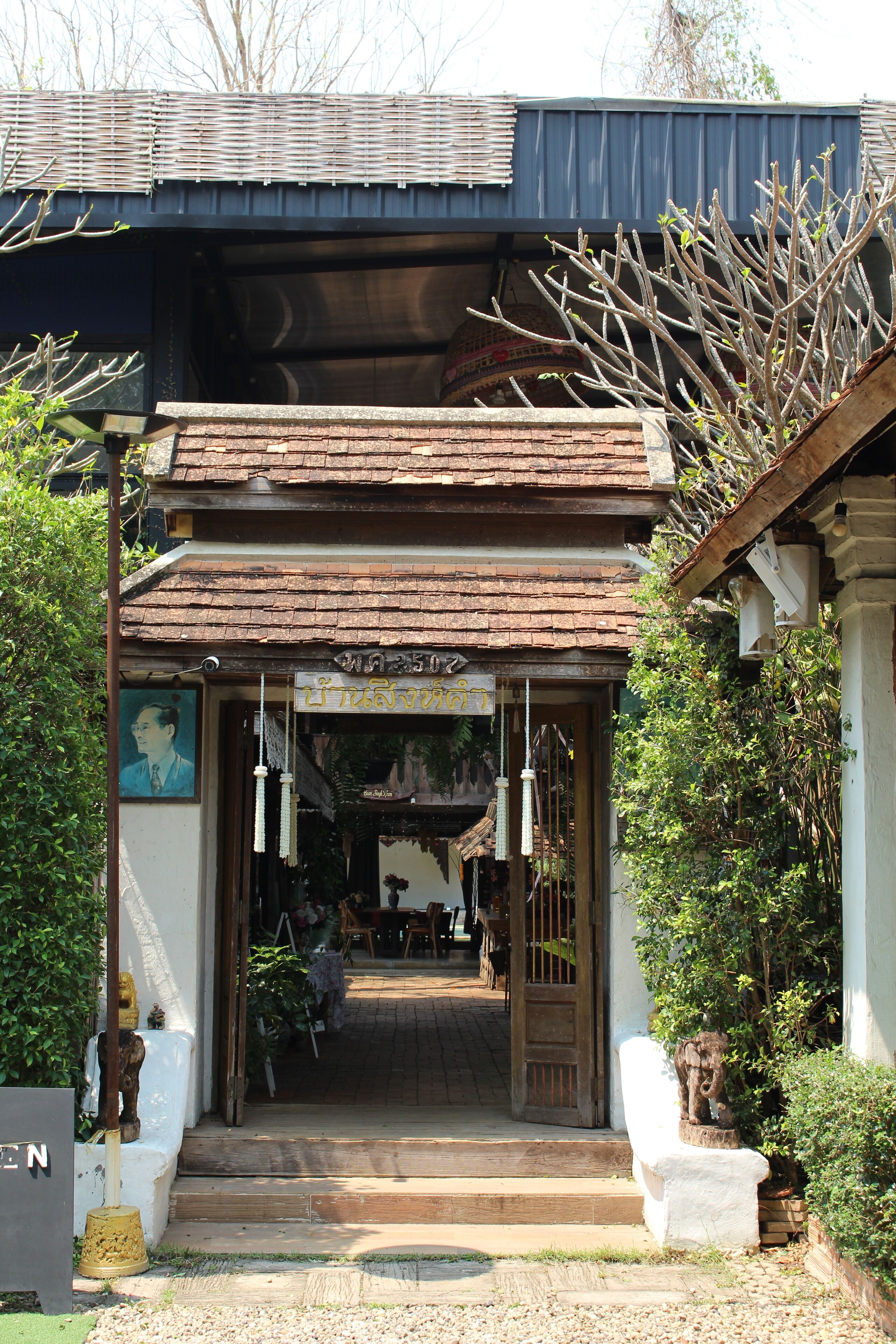 A traditional building with a tiled roof, a wooden door, and a small porch area.
