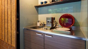 A kitchen with a coffee machine, a scale, and a red bowl on the counter. - Sumiya Seica (Takayama)
