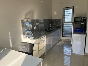 Fridge, microwave, cookware/dishes/utensils, dining tables