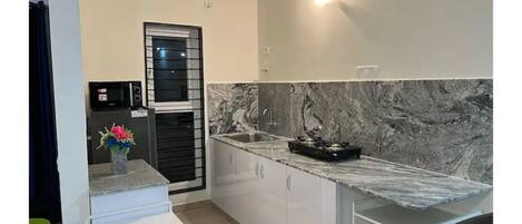 Fridge, microwave, cookware/dishes/utensils, dining tables