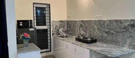 Fridge, microwave, cookware/dishes/utensils, dining tables