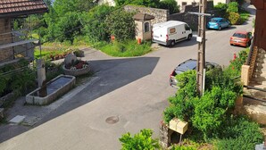 A residential street with houses, a parked van, and a car. - LE RELAIS - LA FERME RÉDON  (Lugrin)