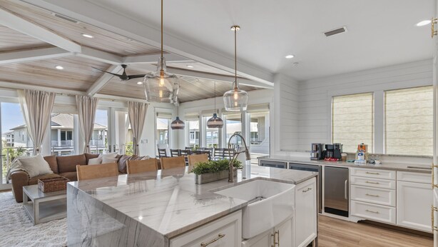 A spacious kitchen with a large island, white cabinetry, and pendant lighting. - 4BR New Luxury Build with Huge Private Pool + Sunset Tower Views | Esmeralda (Destin)