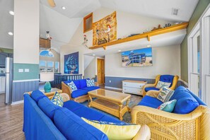 A spacious living area with a high ceiling, a dining area, and a kitchen. - Oceanfront Dog Friendly Home with Hot Tub, Game Room, and Direct Beach Access (Avon)