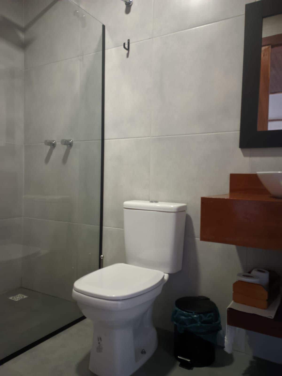 Un baño con inodoro, cabina de ducha y zona de lavabo.