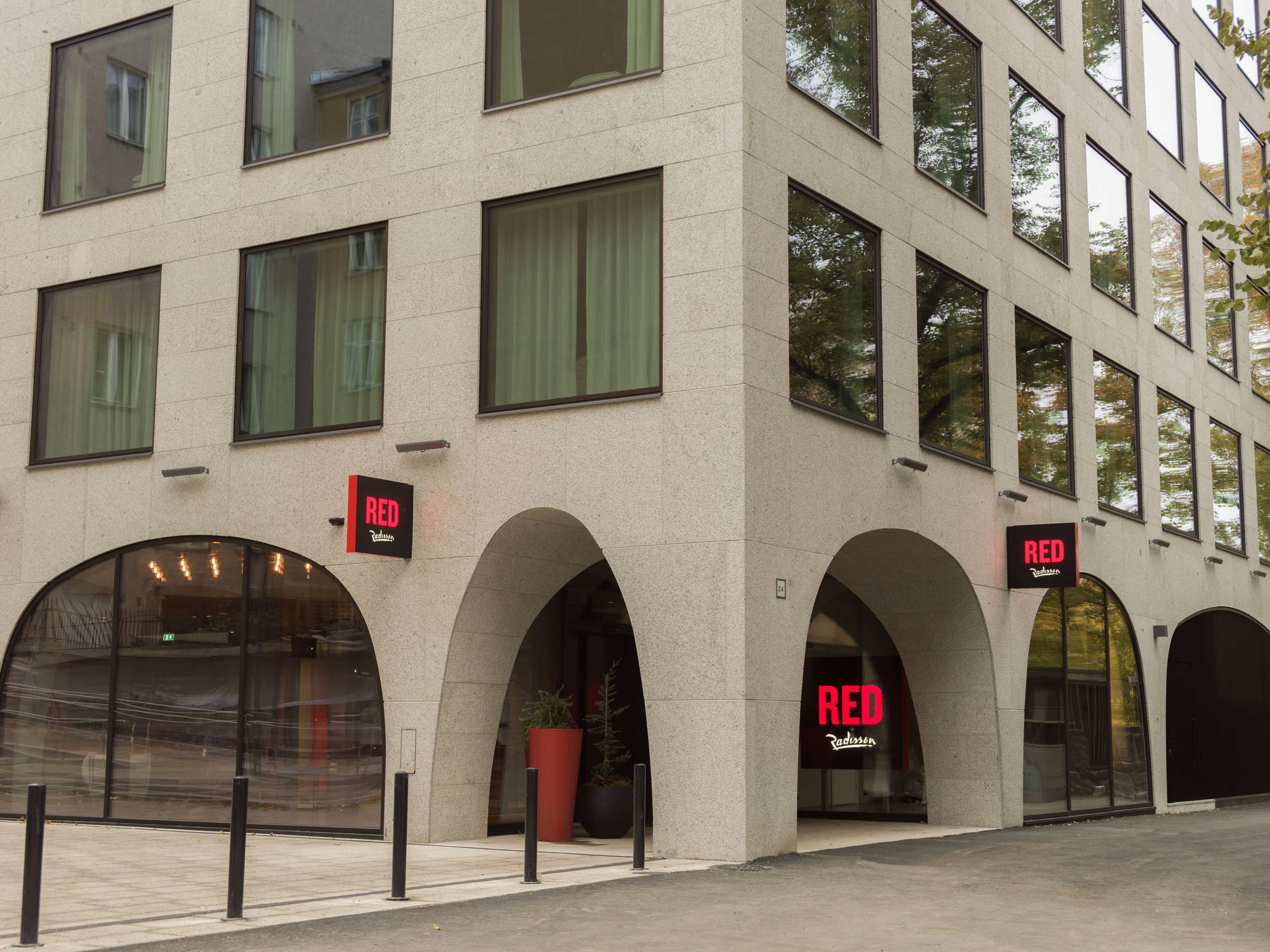 A modern building with multiple windows and arched entrances.