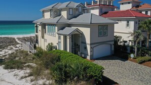 A coastal property with a paved driveway, a gated entrance, and a view of the ocean. - Hot Tub - Destiny by the Sea Gated Community- 5-Star Reviews - On the Beach (Destin)