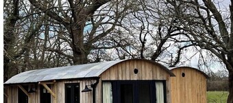 Boutique Shepherds Hut set in a wildflower meadow on a farm with Highland Cows