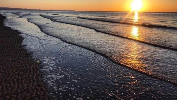 A beach with waves at sunset. - Sleeps 6, Gym, Entertainment, Pool, Beach (Rhyl)