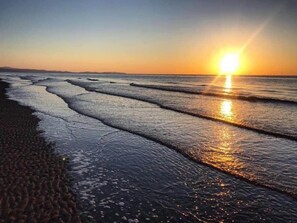 A beach with waves at sunset. - Sleeps 6, Gym, Entertainment, Pool, Beach (Rhyl)