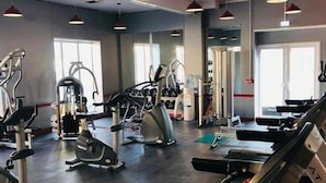 A gym with cardio machines, free weights, and mirrors. - Sleeps 6, Gym, Entertainment, Pool, Beach (Rhyl)