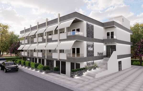 A modern hotel with a multi-story structure, balconies, and a stone accent wall. - Plagia Relax Hotel (Nea Propontida)