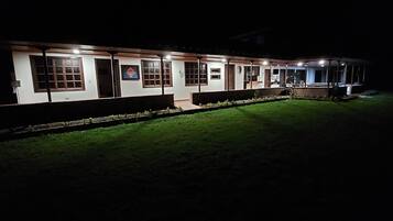 Guest rooms offer doors and windows with a beautifully maintained lawn outside.
