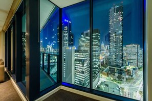 Enjoy breathtaking city views from the comfort of your room, with floor-to-ceiling windows framing the urban landscape.