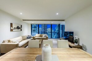 Relax in this stylish living room with a city view, flat-screen TV, and comfortable seating area.