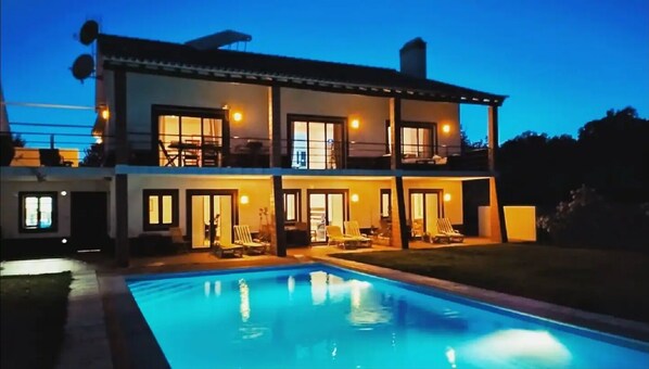 Relax by the pool in a spacious outdoor area with lounge chairs.