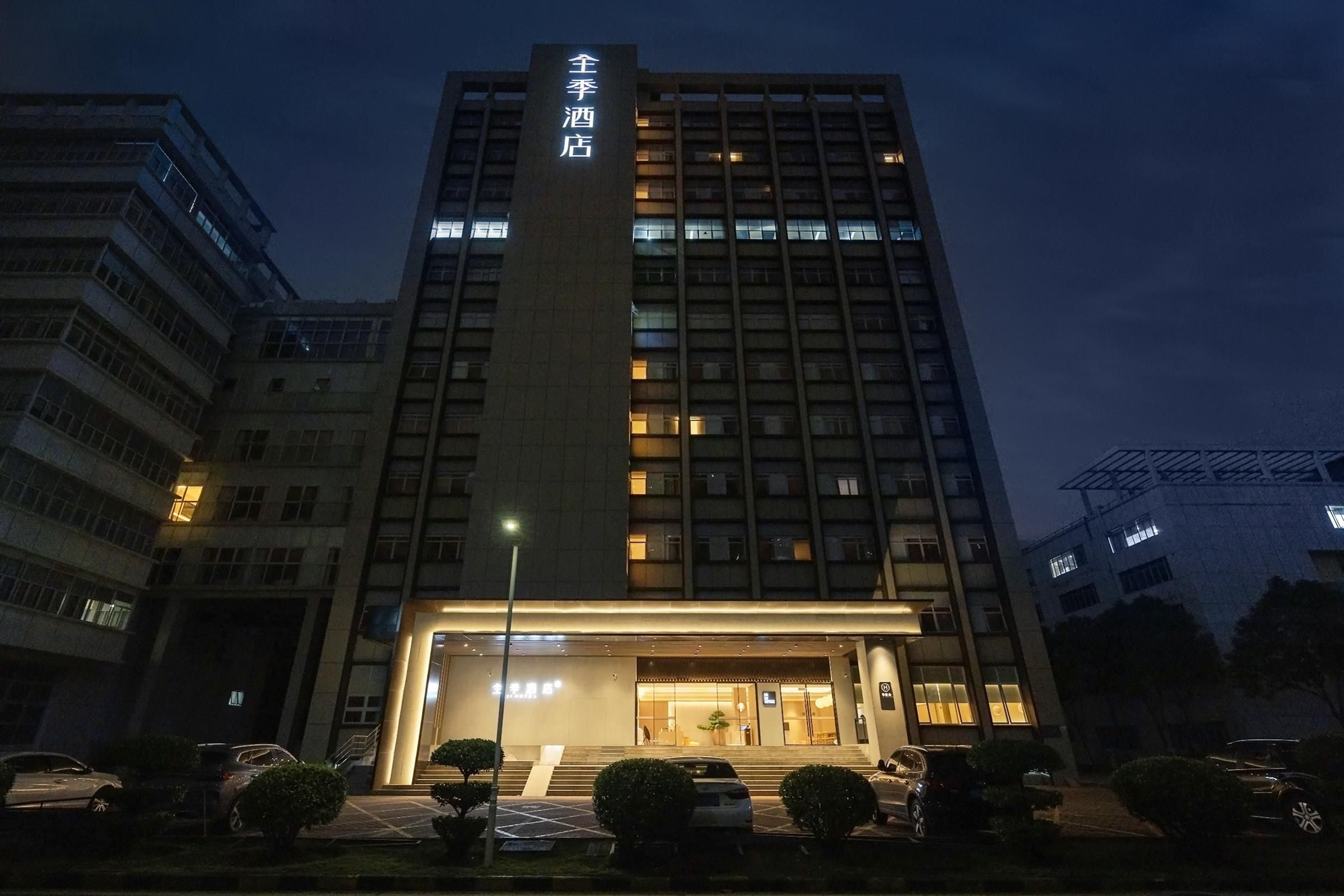 A hotel building with a prominent entrance and a sign indicating it is a hotel.