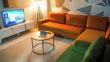 Deluxe Suite, 1 Bedroom | Living area | 30-inch flat-screen TV with cable channels, TV