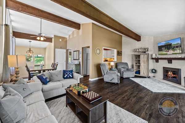 Expansive open-concept living space featuring sleek modern kitchen with stainless steel appliances and elegant dining area