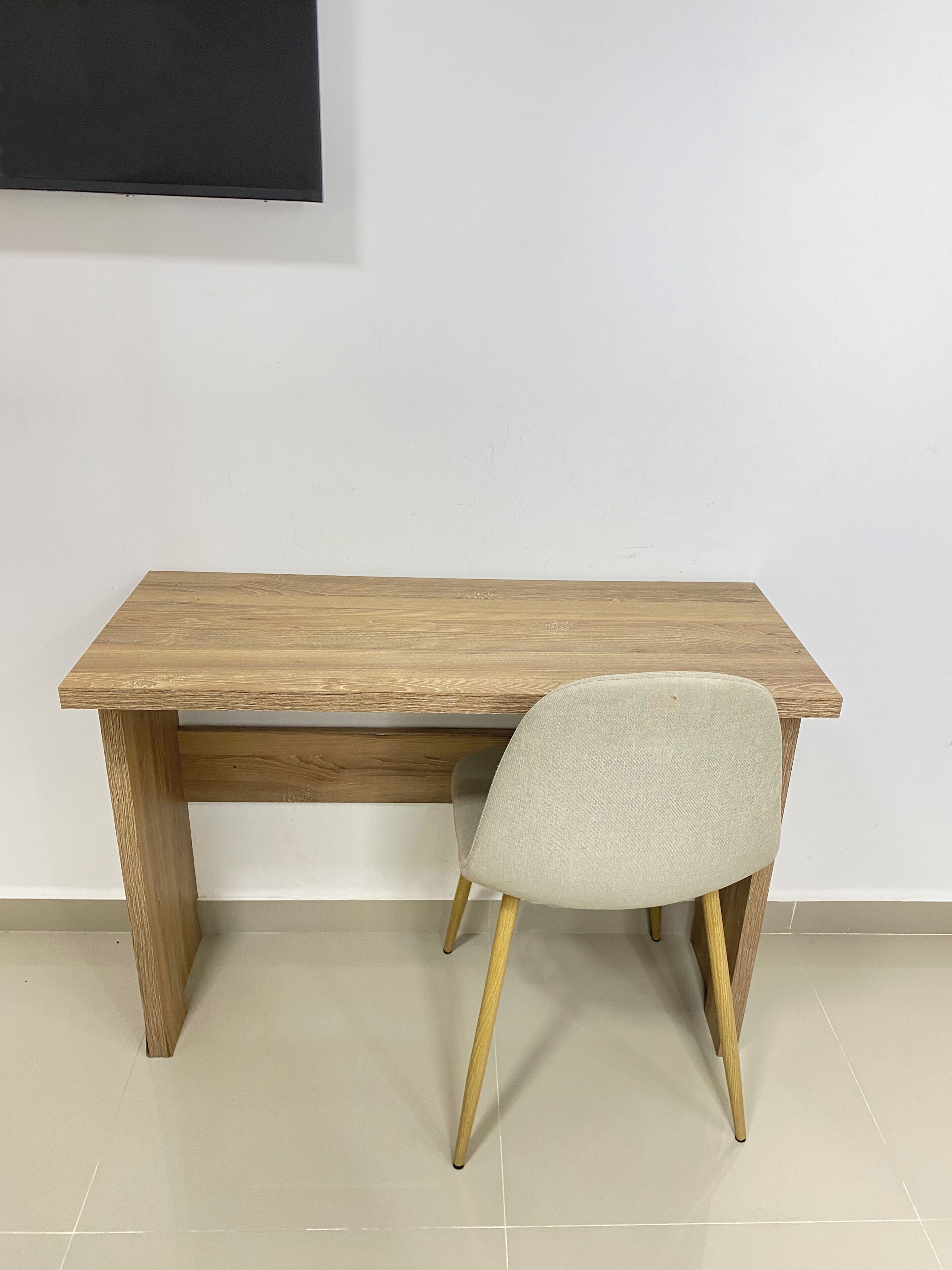 A wooden table with a chair.