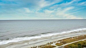 A coastal landscape with a beach and a clear sky. - Breathtaking 2BR Condo w Floor-to-Ceiling Windows Overlooking Ocean (Myrtle Beach)
