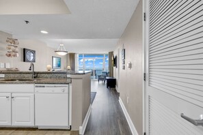 Enjoy cooking in this well-equipped kitchen with a central island, dishwasher, and sink, and dine with a view of the outdoors through large windows.