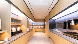 Una cocina moderna con armarios de madera, electrodomésticos de acero inoxidable y una encimera amplia.