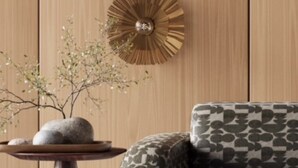 A room with a wooden wall, a patterned sofa, and a round wall decoration. - Wonderful Country Side Home, Winchester near River Test, Winchester Cathedral 6k (Winchester)
