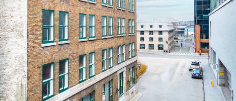 A multi-story brick building with large windows and a flat roof.