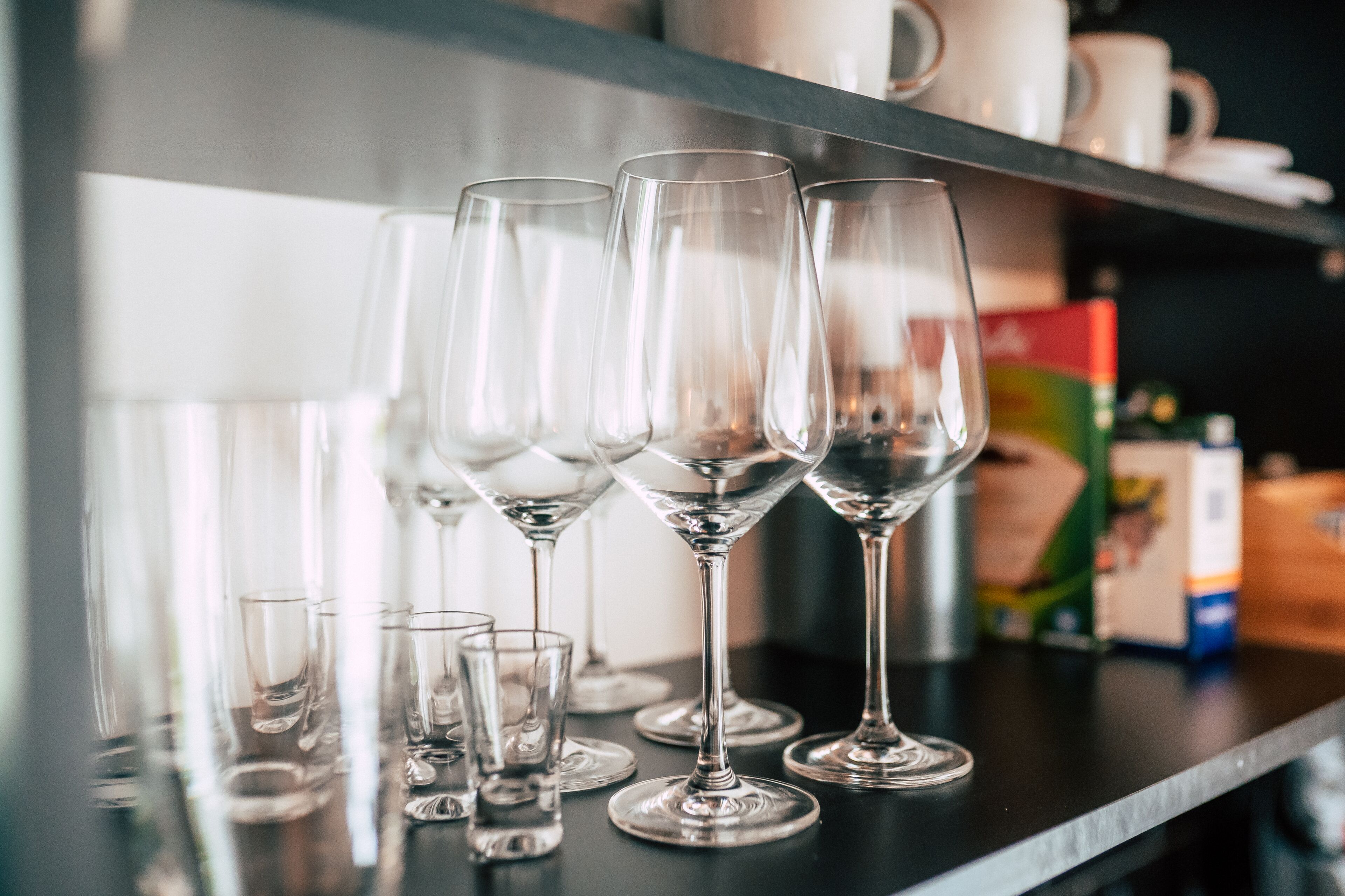 A row of empty wine glasses on a counter.