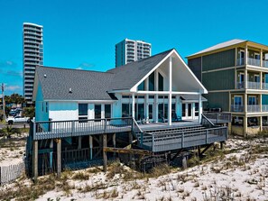 A beachfront hotel with a covered patio, a deck, and a view of the ocean. - Escape to Sun Dreams 1 Your Perfect Gulf Shores Getaway Direct Gulf Front by Prickett Properties (Gulf Shores)