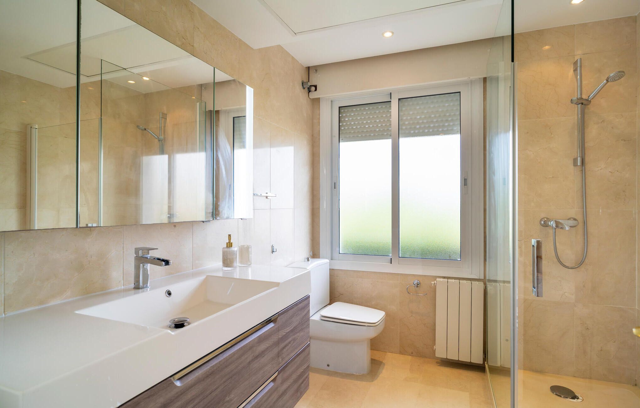 Une salle de bain moderne avec un grand lavabo, des toilettes et une douche.
